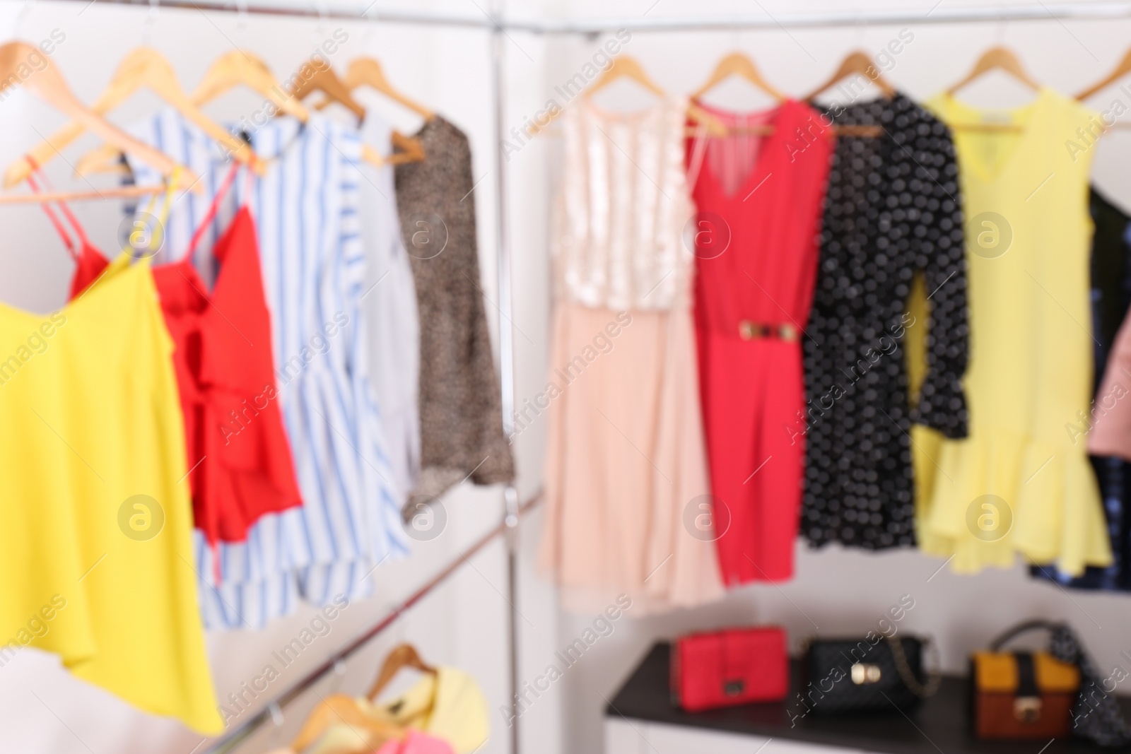 Photo of Blurred view of dressing room with different clothes and accessories