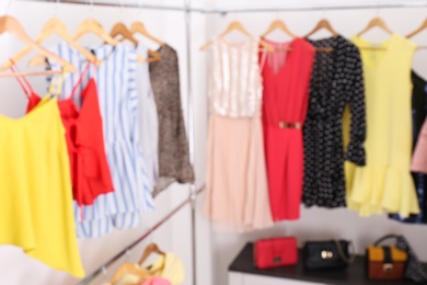 Blurred view of dressing room with different clothes and accessories