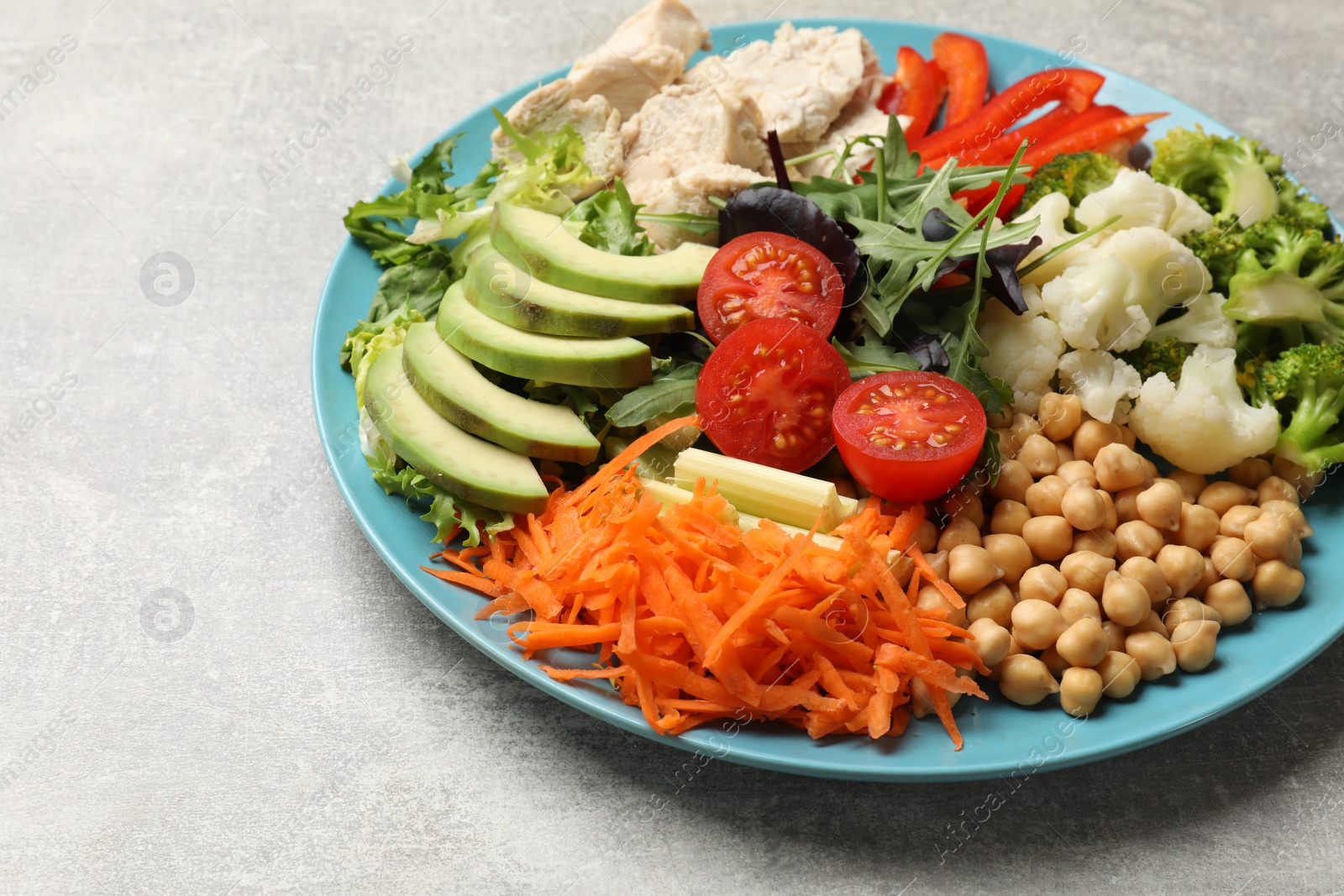 Photo of Balanced diet and healthy foods. Plate with different delicious products on grey table, closeup