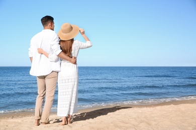 Photo of Lovely couple on beach. Space for text