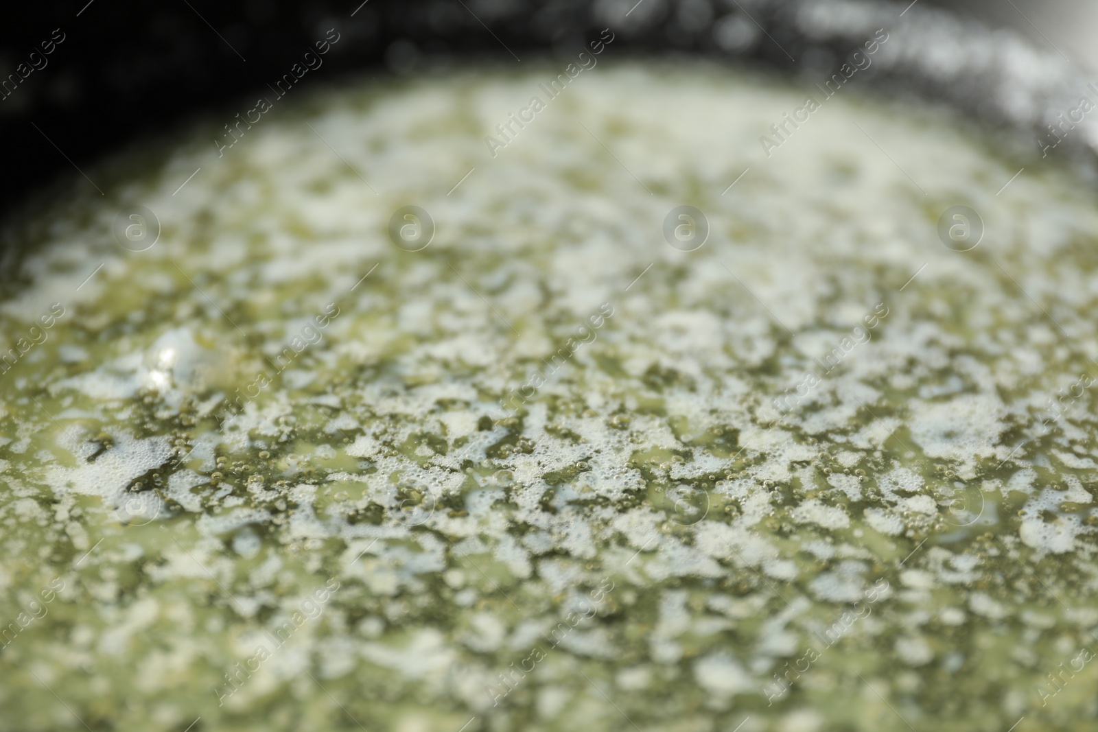 Photo of Melting butter in frying pan, closeup view