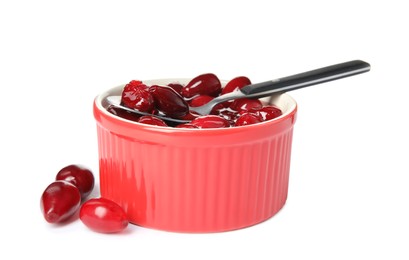 Delicious dogwood jam with berries and spoon on white background