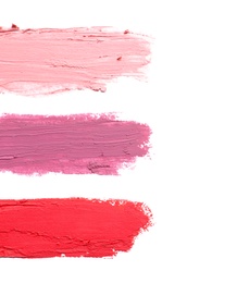 Photo of Strokes of lipstick on white background, top view