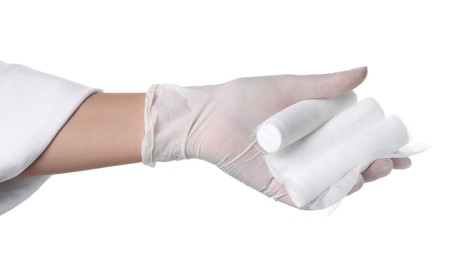 Photo of Doctor holding gauze bandage rolls on white background, closeup