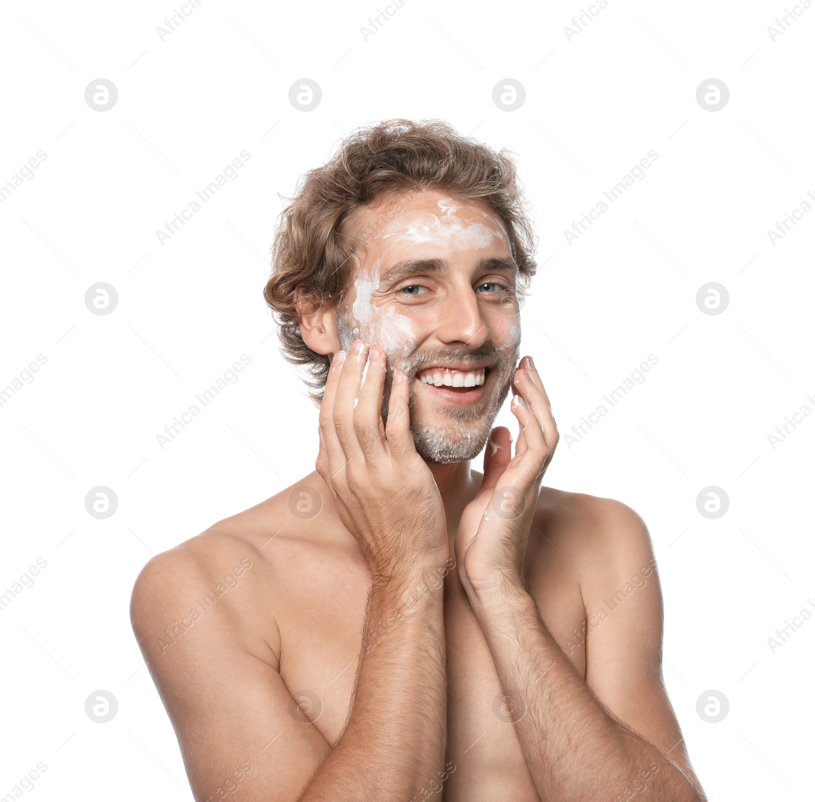 Photo of Young man washing face with soap on white background