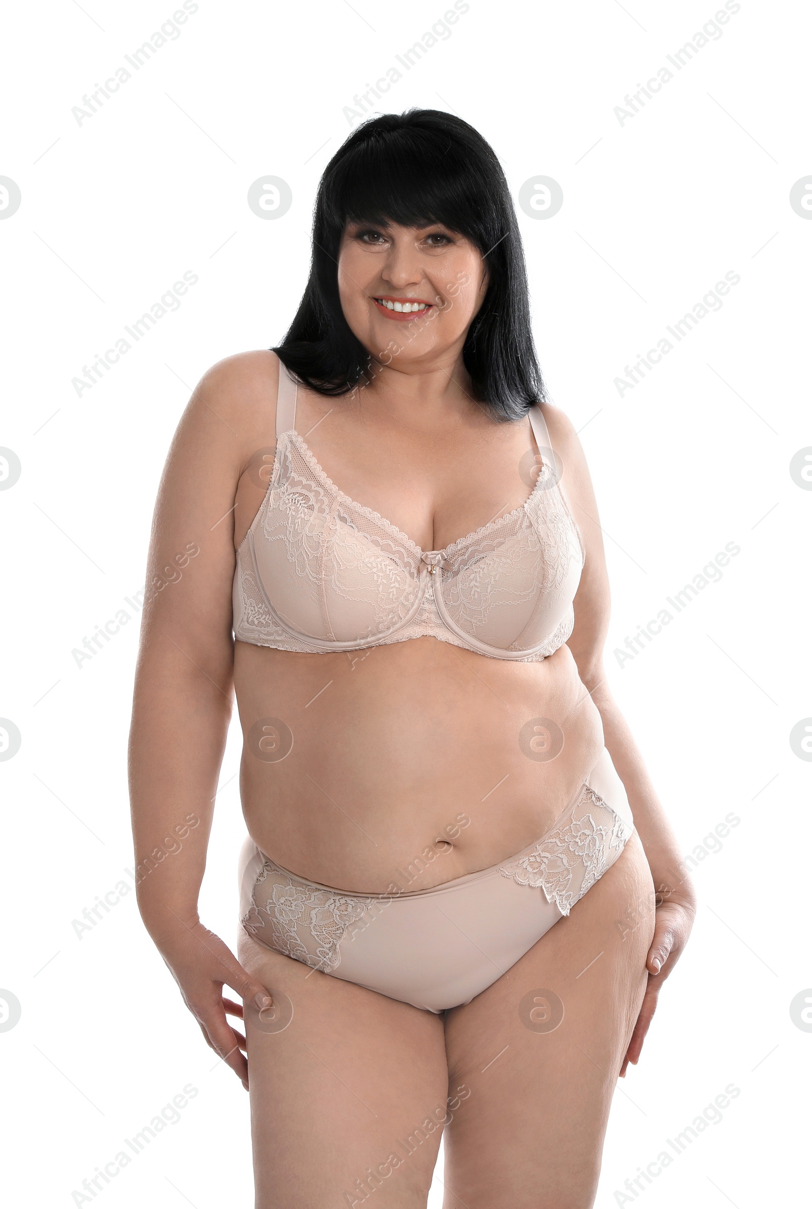 Photo of Beautiful overweight woman in beige underwear on white background. Plus-size model