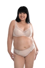 Beautiful overweight woman in beige underwear on white background. Plus-size model