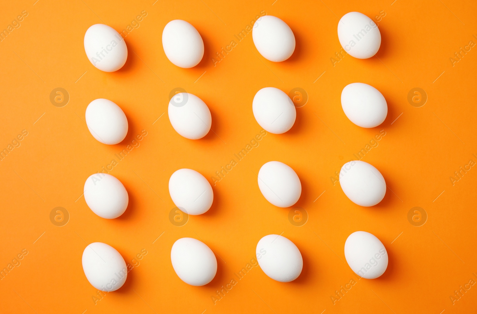 Photo of Raw chicken eggs on color background, top view