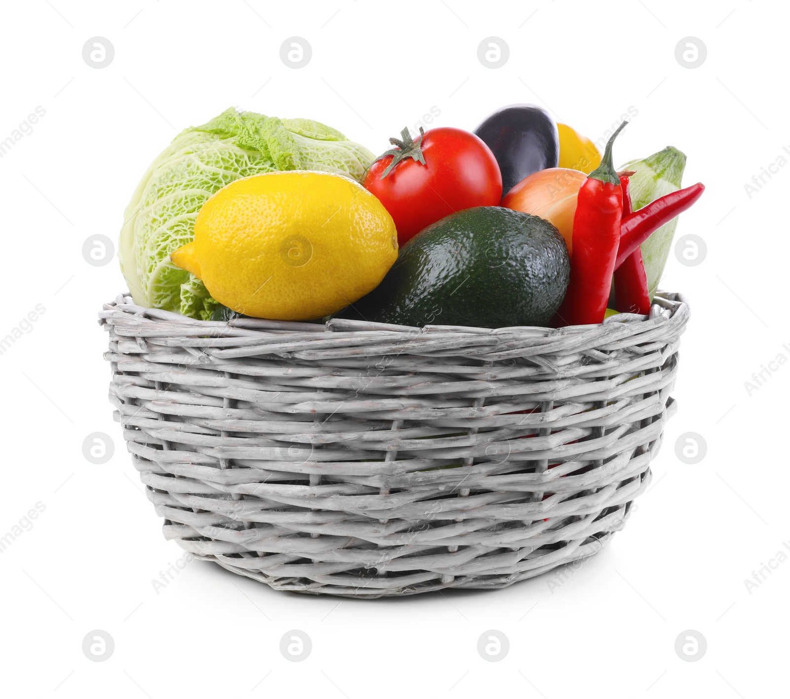Photo of Wicker basket with fresh ripe vegetables and fruit on white background