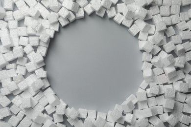 Frame made of styrofoam cubes on grey background, flat lay. Space for text