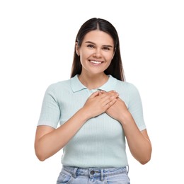Photo of Thank you gesture. Beautiful grateful woman holding hands near heart on white background