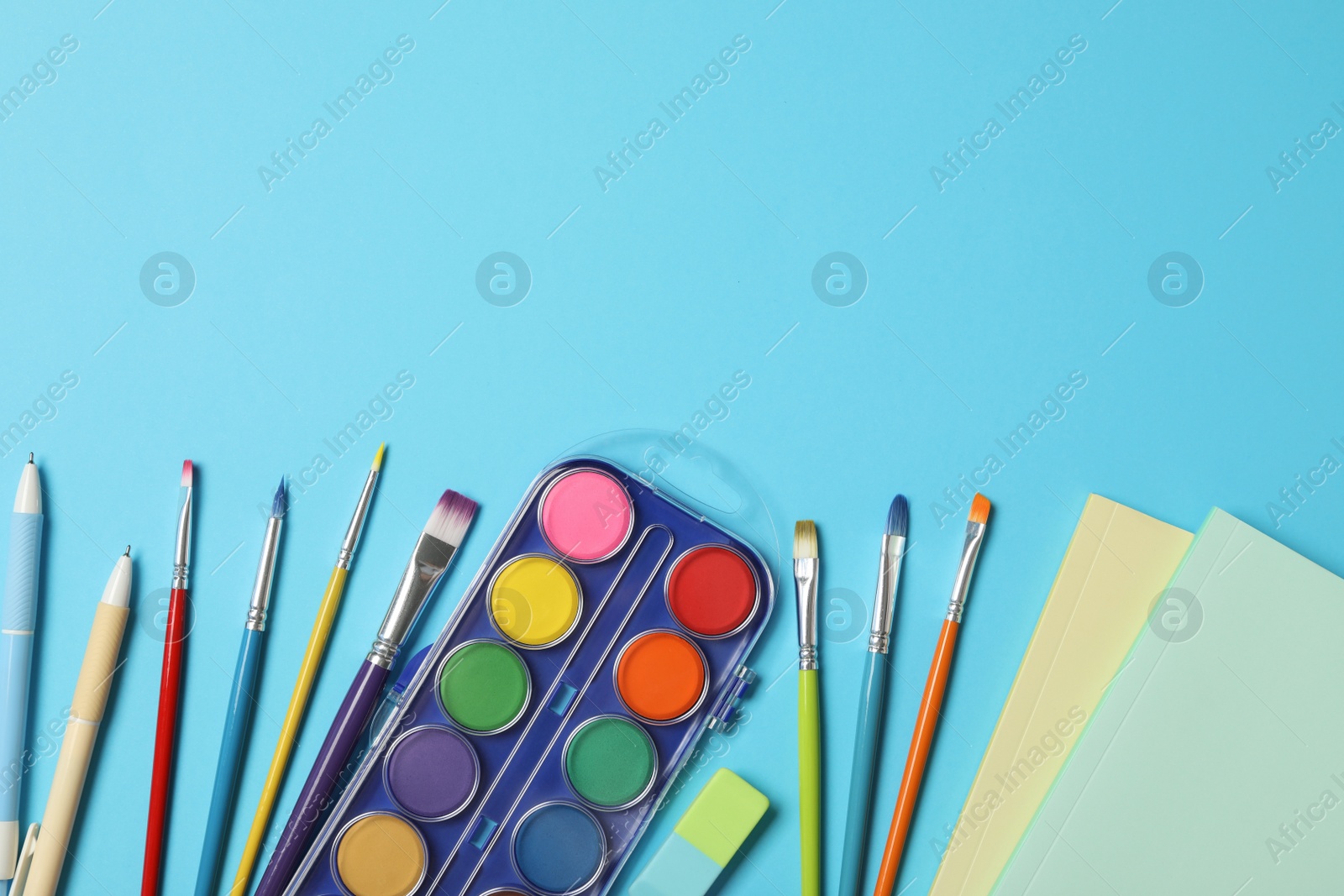 Photo of Different stationery on light blue background, flat lay with space for text. Back to school