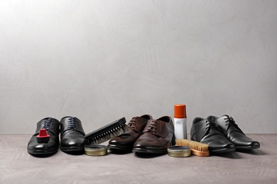 Footwear and shoe shine kit on grey surface, space for text