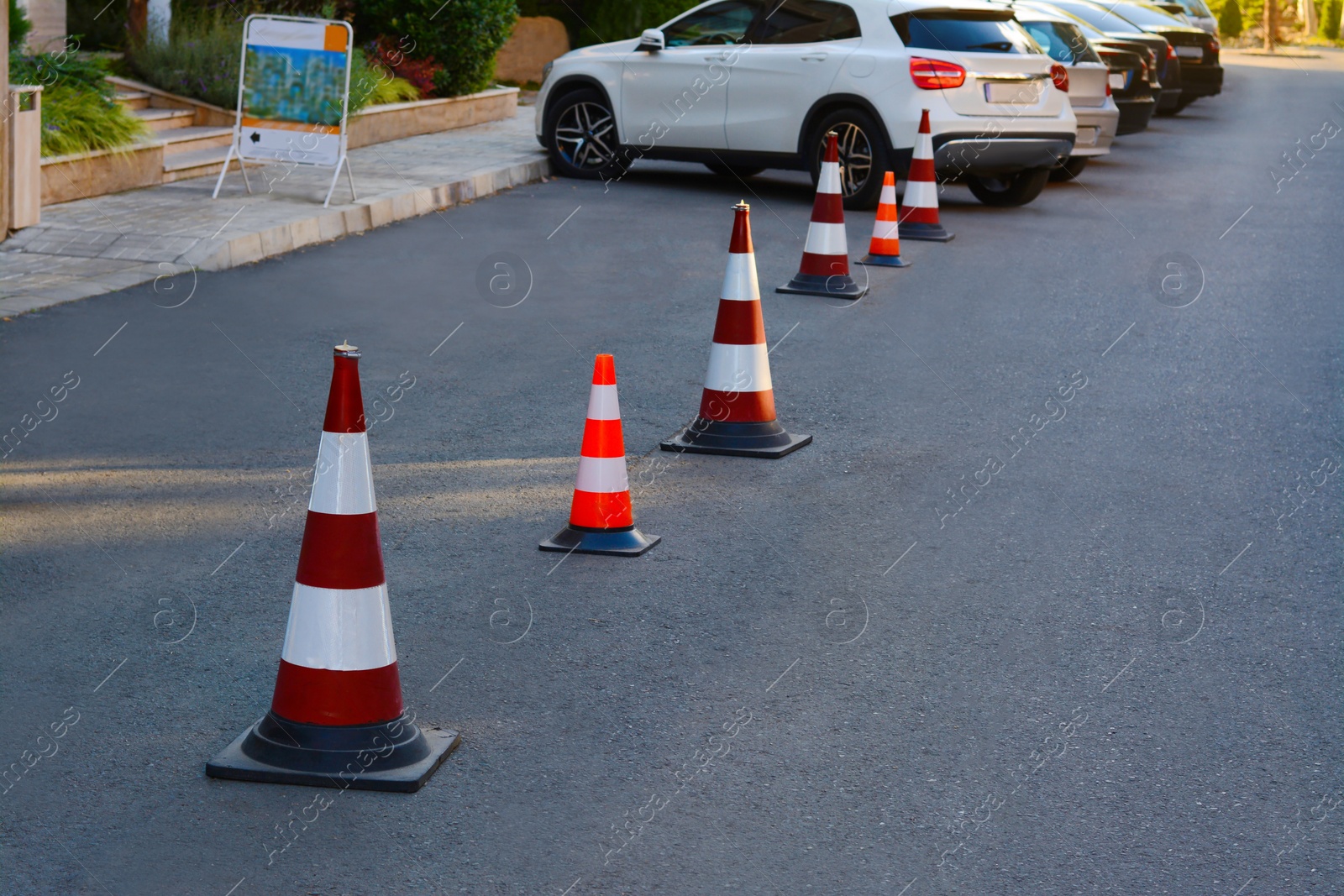 Photo of Traffic cones near cars on asphalt outdoors