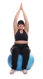 Photo of Happy overweight mature woman sitting on fitness ball against white background