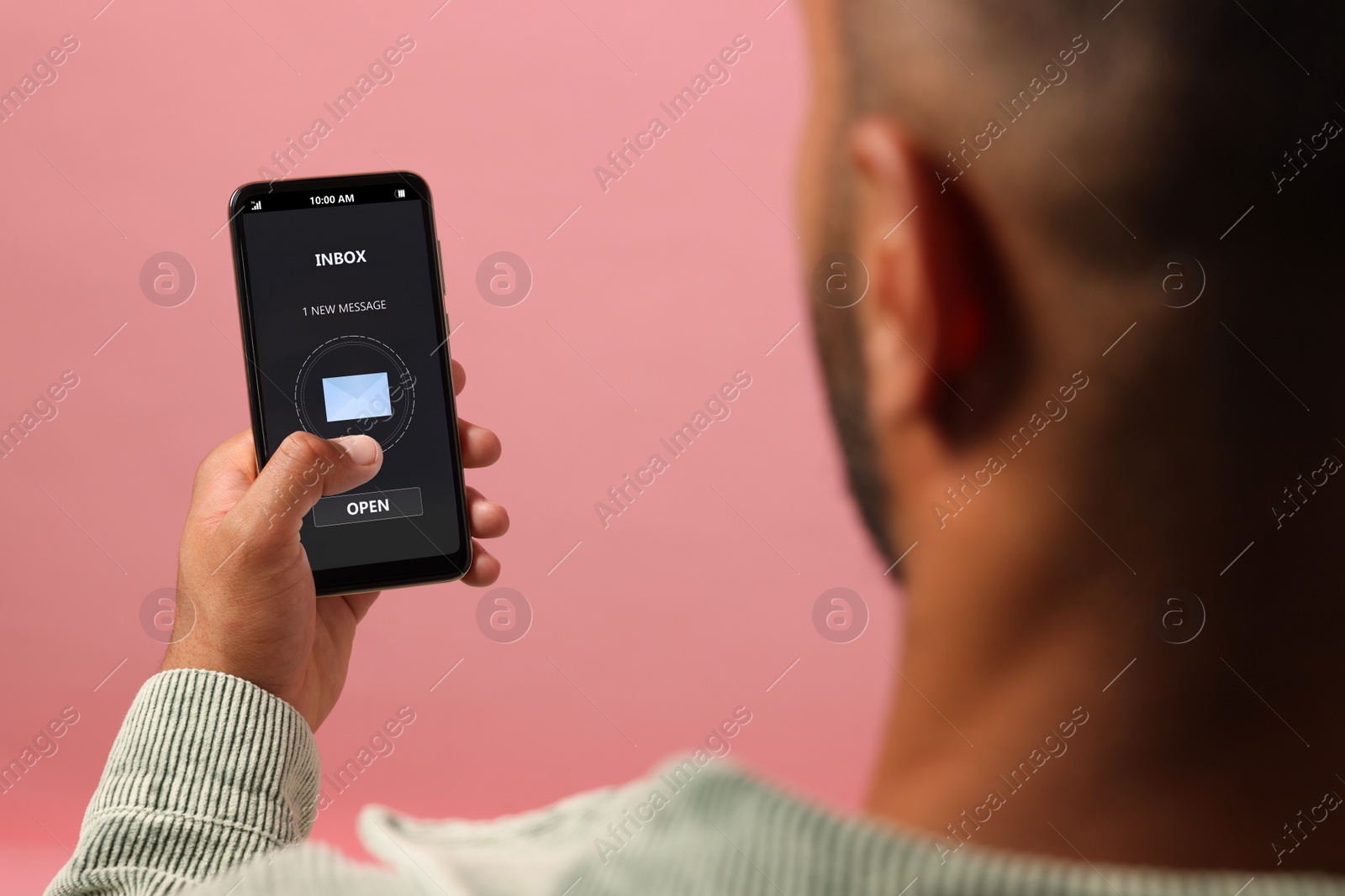 Image of Got new message. Man using smartphone on pink background, closeup