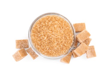 Different types of brown sugar and bowl isolated on white, top view