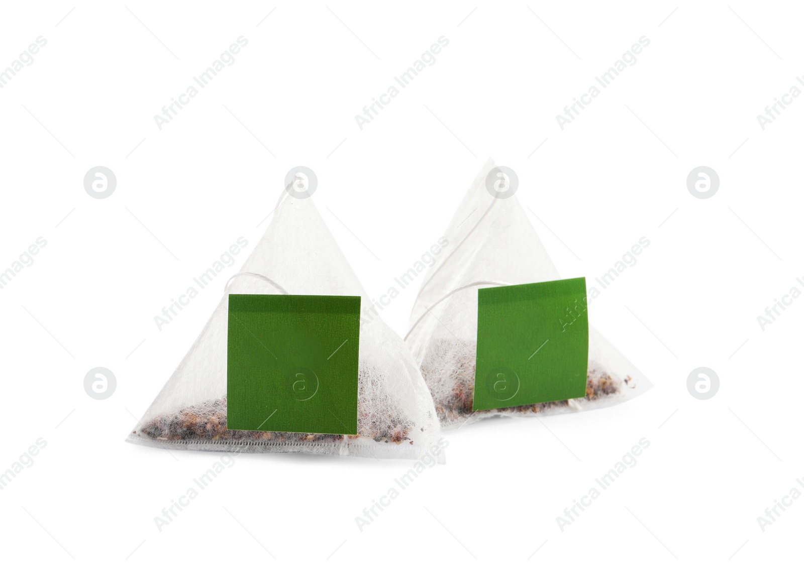 Photo of New pyramid tea bags on white background