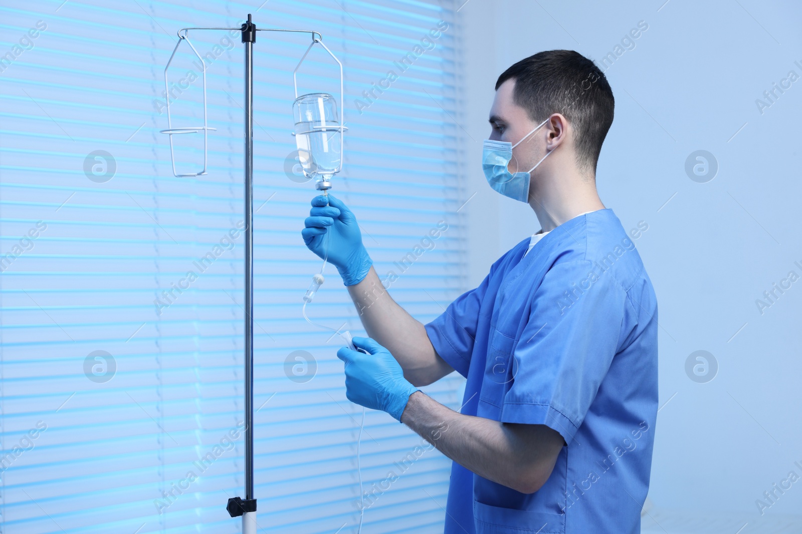 Photo of Nurse setting up IV drip in hospital