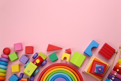 Photo of Different children's toys on pink background, flat lay. Space for text