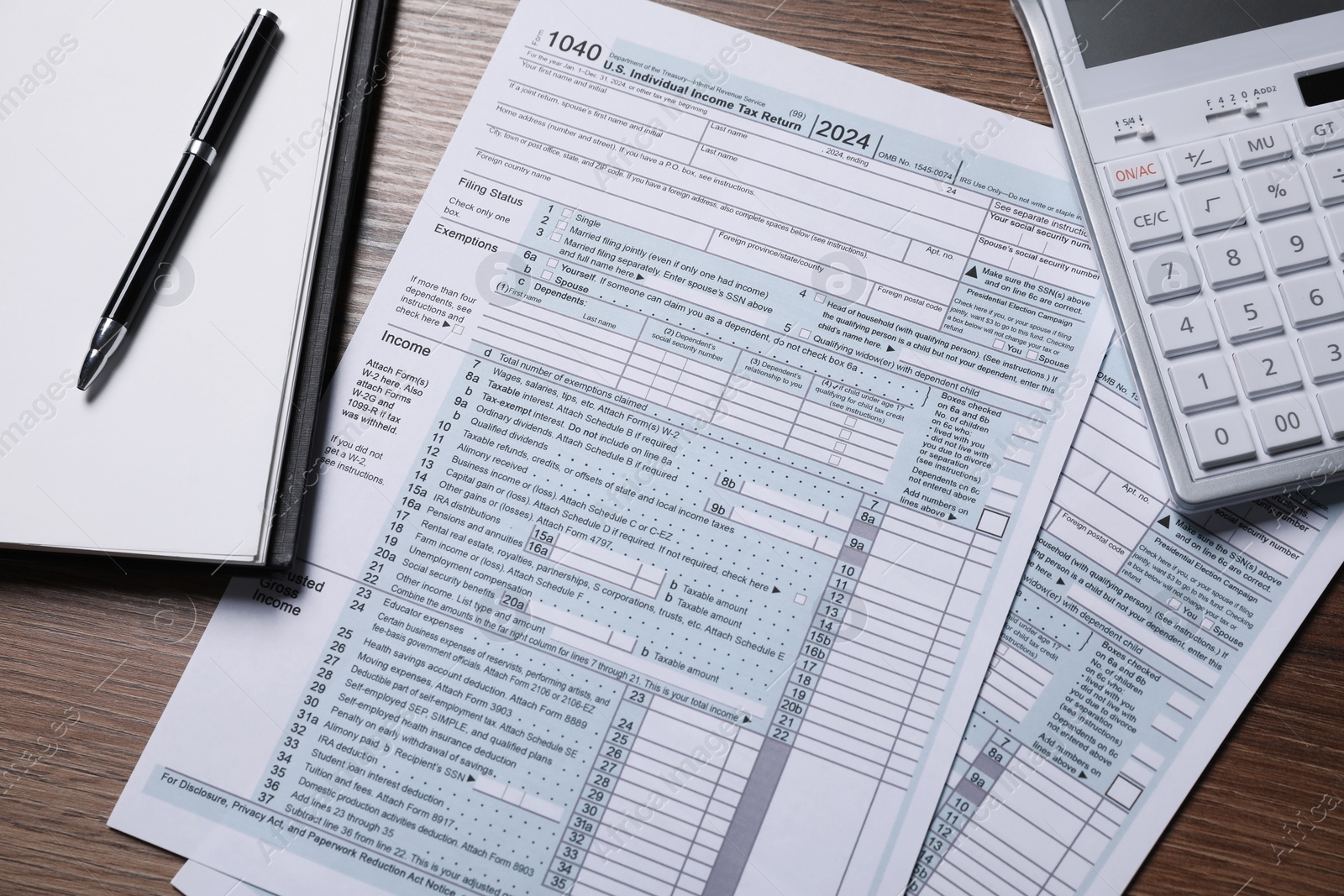 Photo of Payroll. Tax return forms, calculator, notebook and pen on wooden table, flat lay