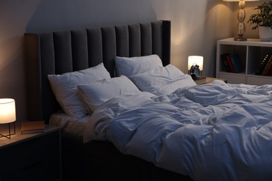 Photo of Soft bed, nightlights and cozy furniture indoors