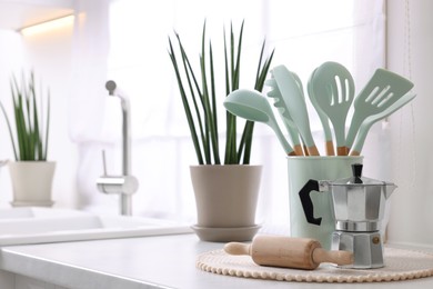 Set of different utensils on countertop in kitchen, space for text