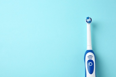 Photo of Electric toothbrush on color background. Dental care