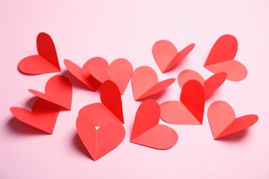 Photo of Small paper hearts on color background