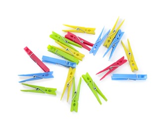 Photo of Colorful plastic clothespins on white background, above view