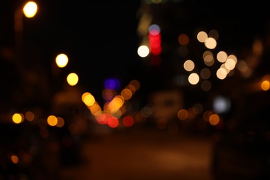 Photo of Blurred view of city street with lights at night. Bokeh effect