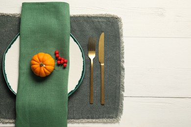 Photo of Autumn table setting, pumpkin and red berries, flat lay. Space for text