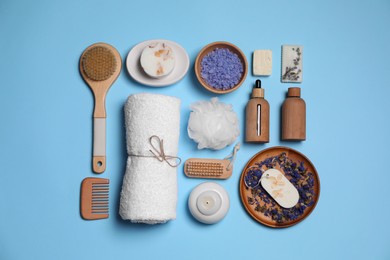 Flat lay composition with different spa products on light blue background