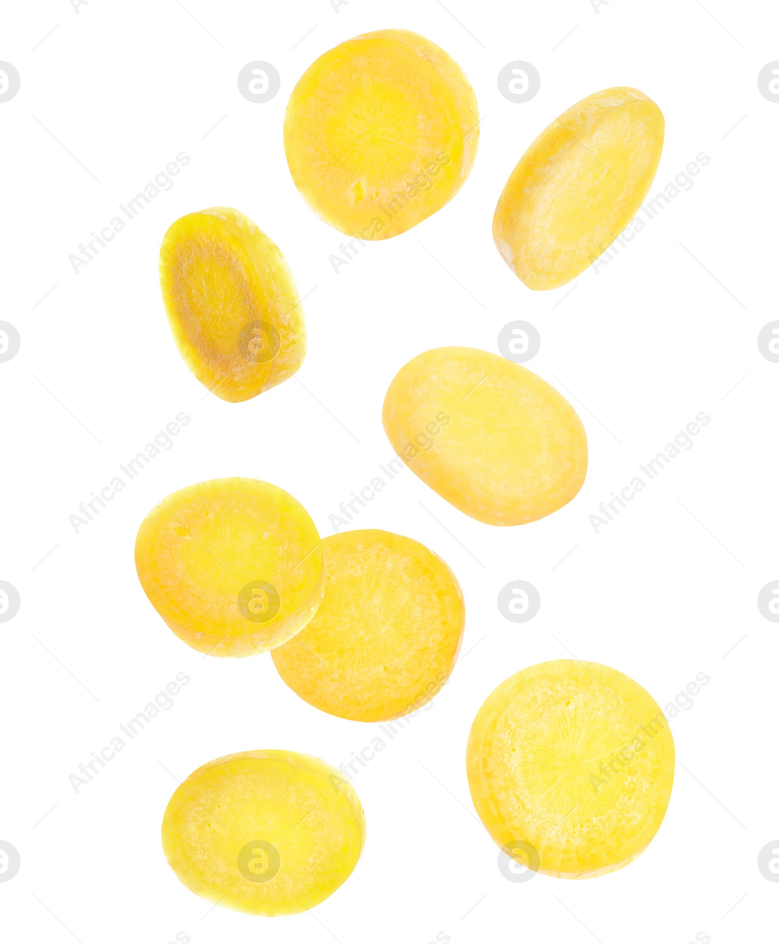 Image of Yellow carrot slices falling on white background