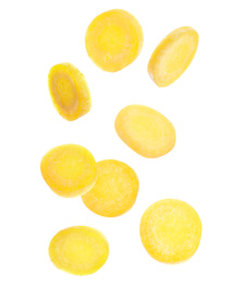 Yellow carrot slices falling on white background