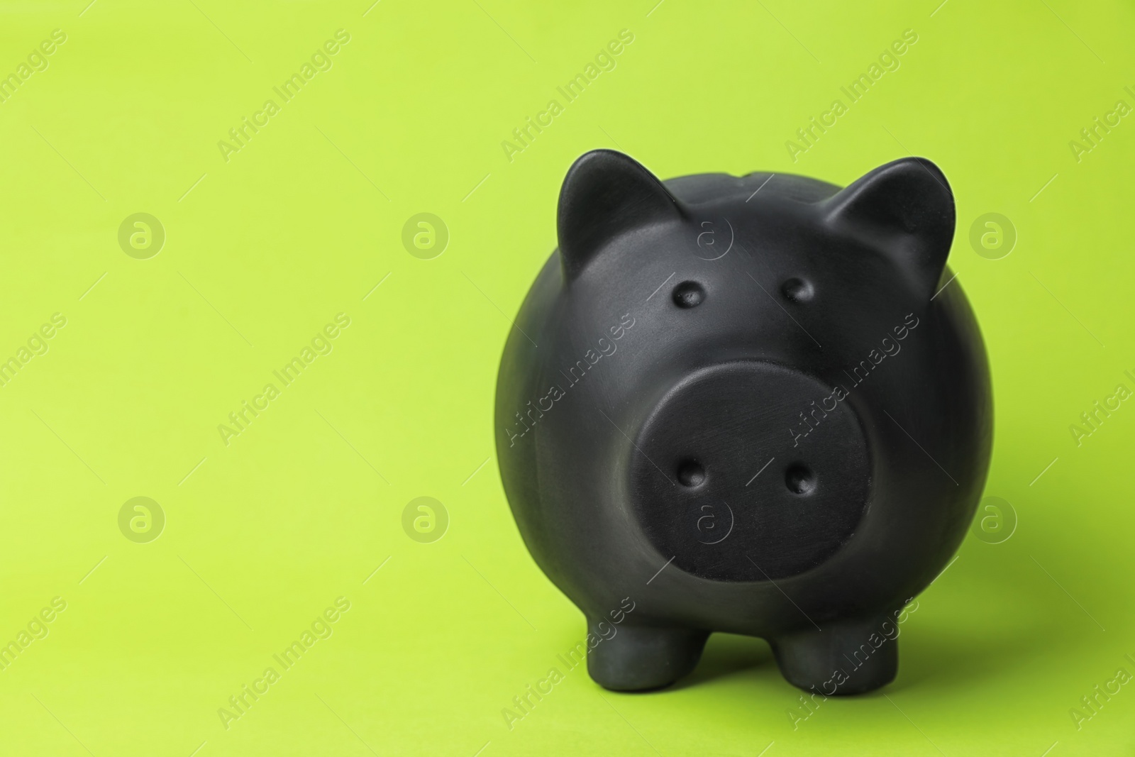 Photo of Black piggy bank on color background. Money saving