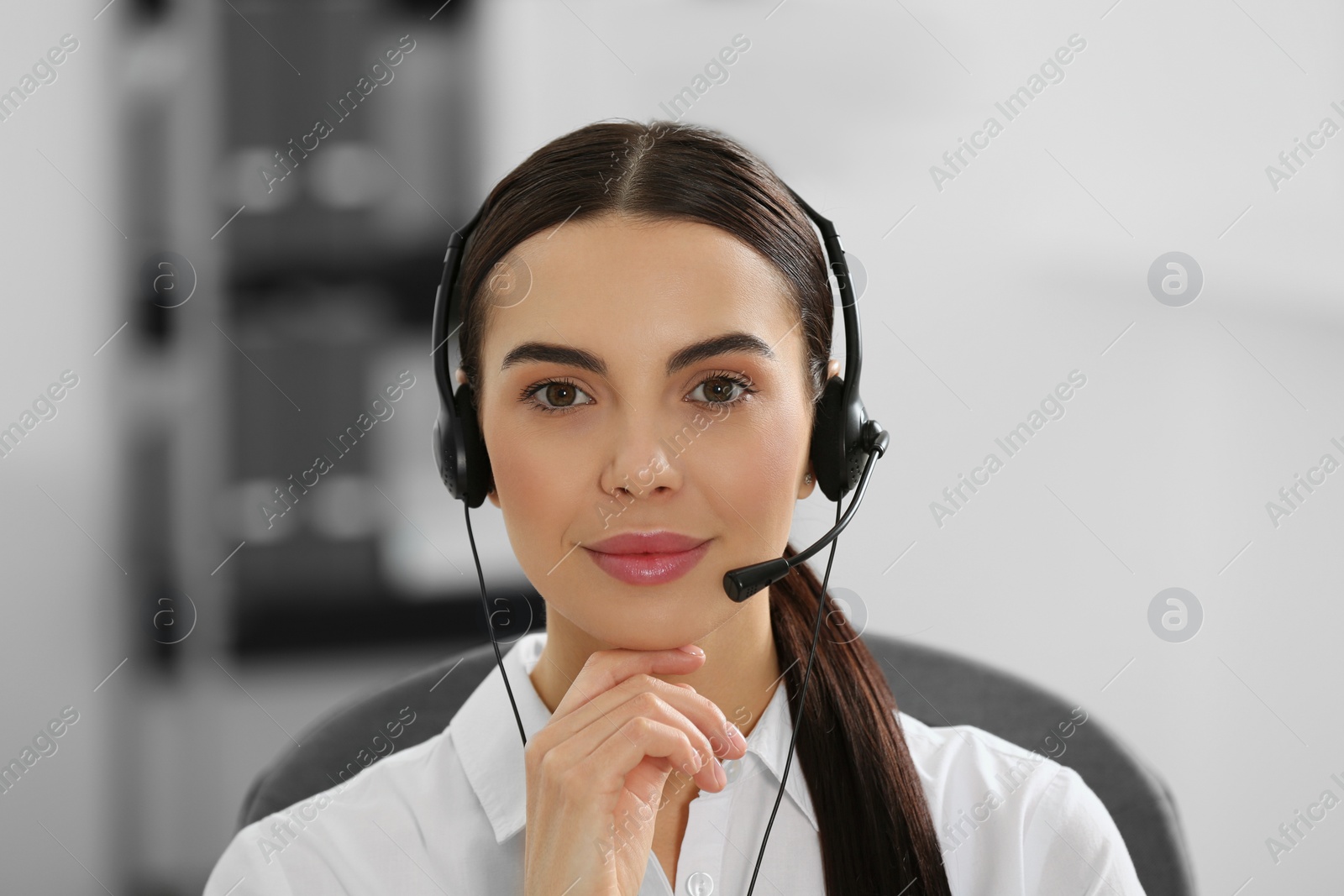 Photo of Hotline operator with headset working in office