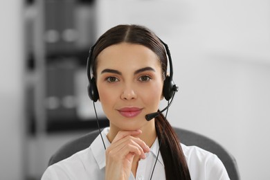 Hotline operator with headset working in office