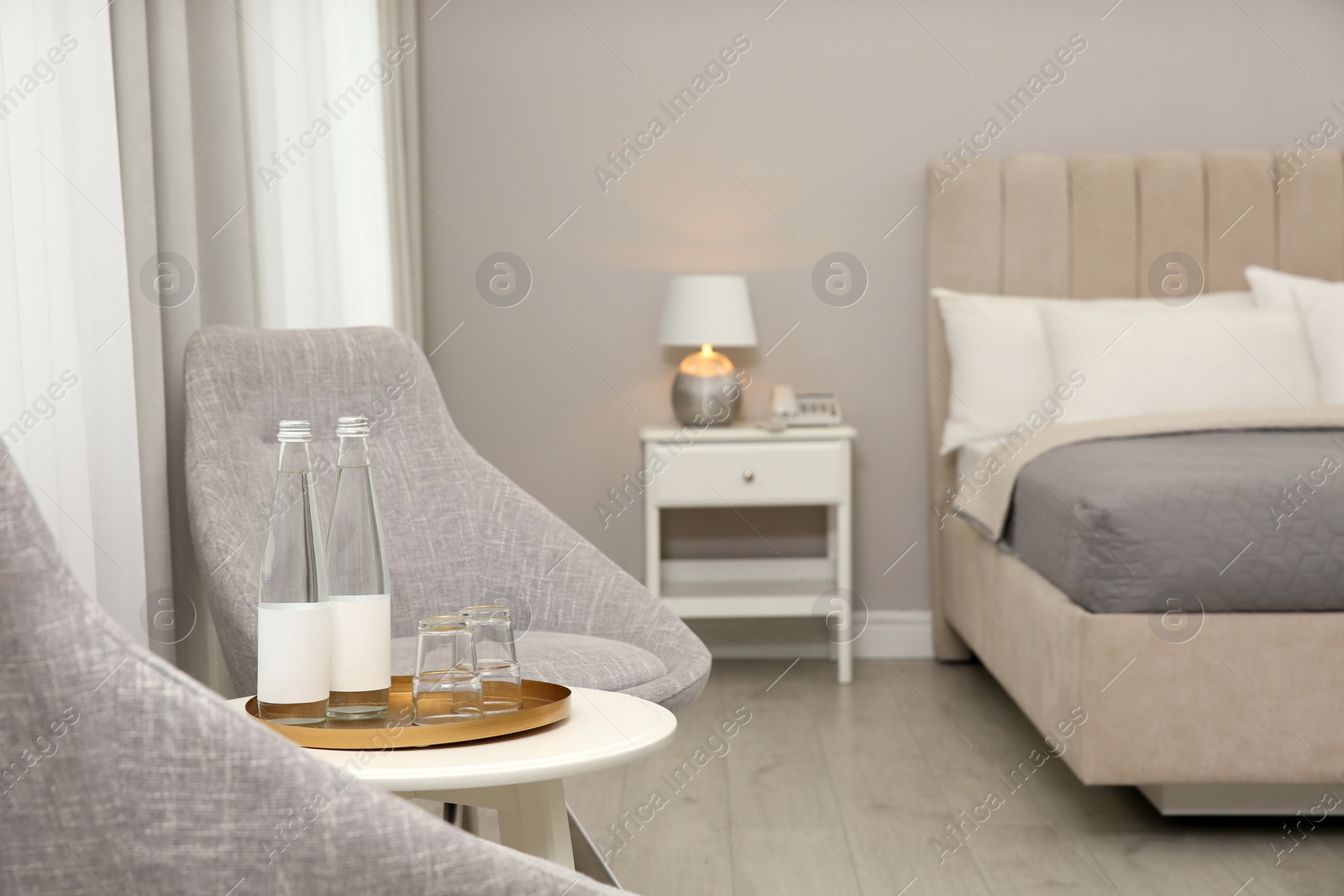 Photo of Beautiful hotel room interior with double bed and chairs