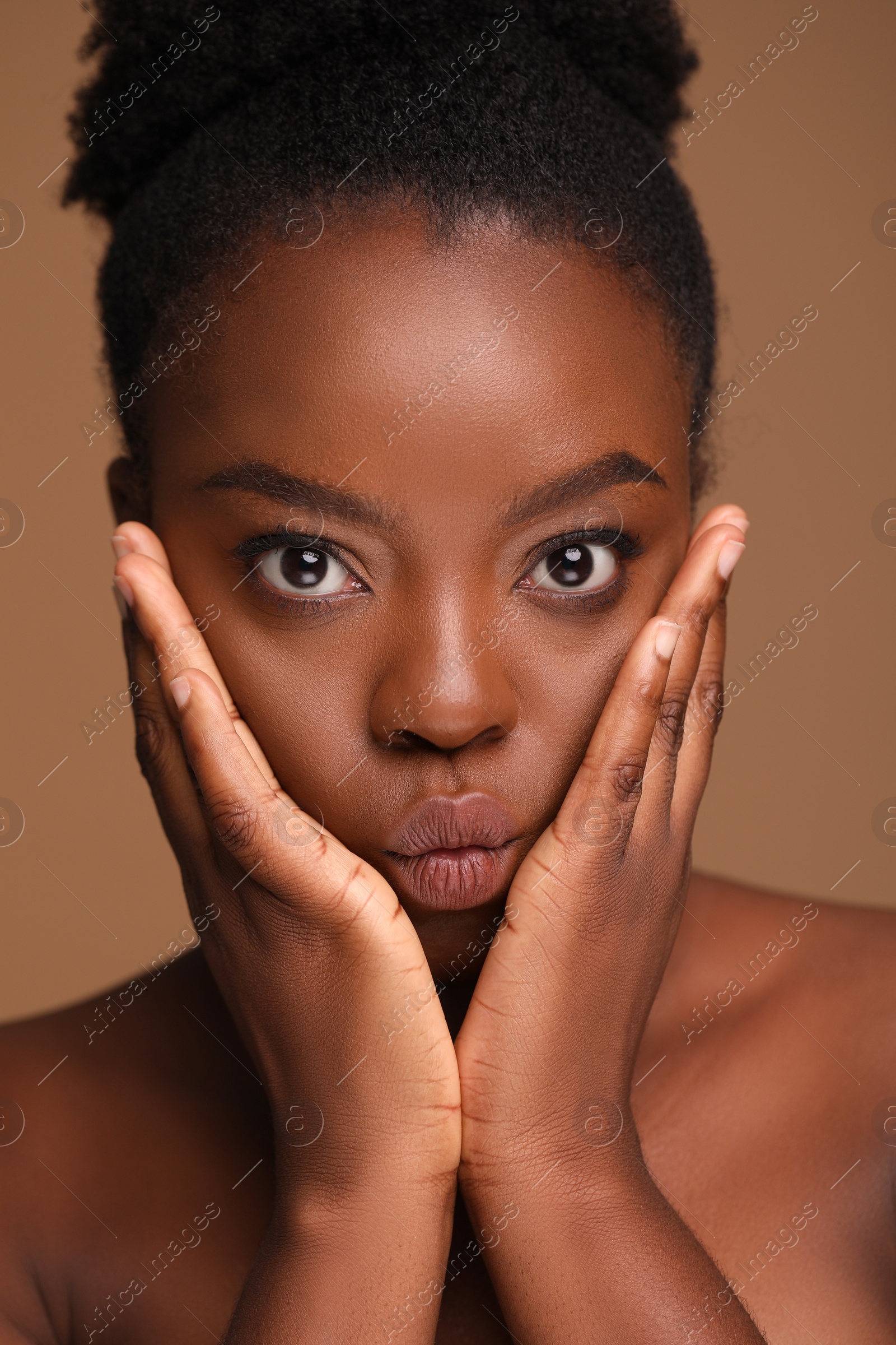 Photo of Portrait of beautiful woman on light brown background, closeup