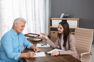 Lawyer having meeting with senior client in office