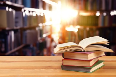 Image of Many books on wooden table in library. Space for text 