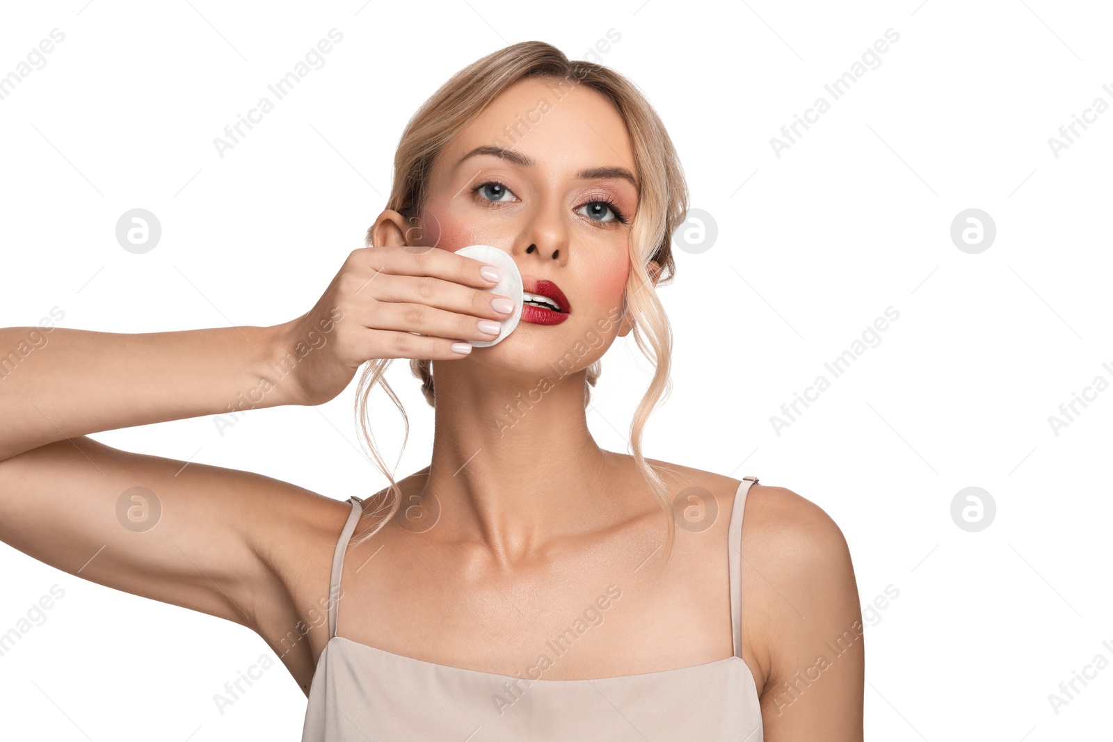 Photo of Beautiful woman removing makeup with cotton pad on white background