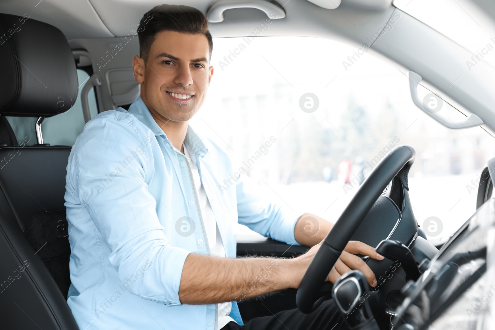 Photo of Handsome man driving his new modern car