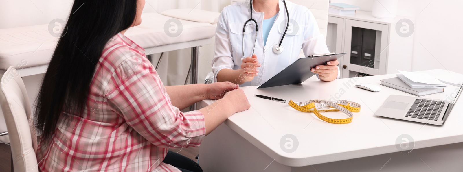 Image of Overweight woman consulting with nutritionist in clinic, closeup. Banner design