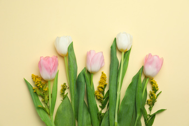 Photo of Flat lay composition with spring flowers on yellow background