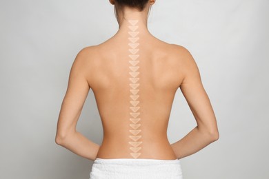 Woman with healthy back on light background, closeup. Illustration of spine