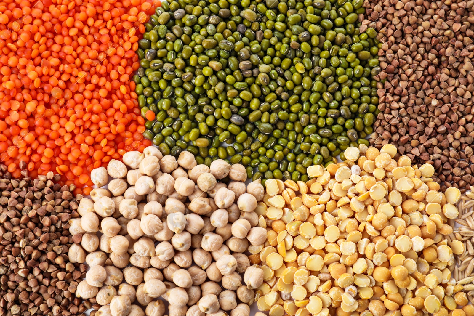 Photo of Different grains and cereals as background, top view