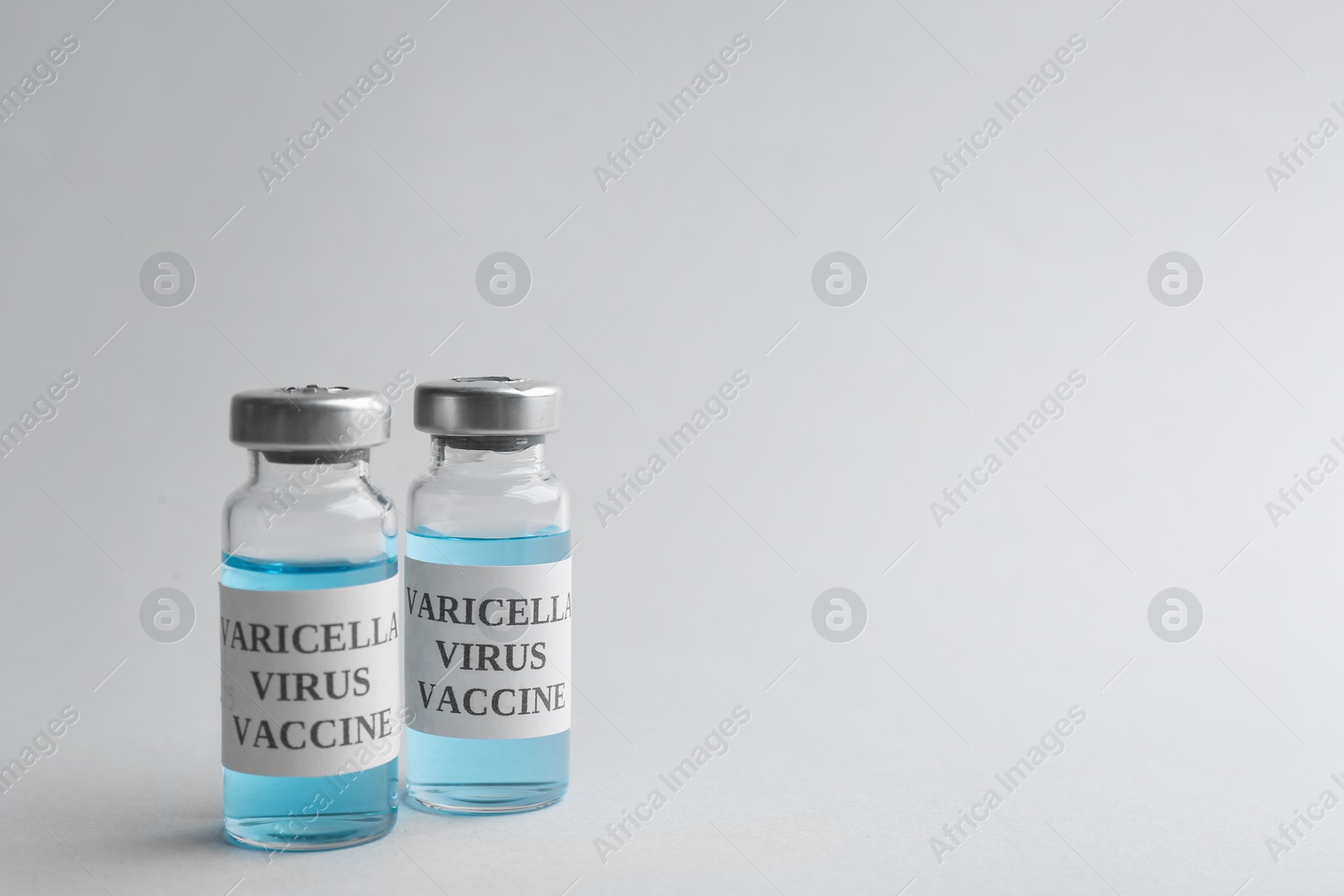 Photo of Chickenpox vaccine on light grey background, space for text. Varicella virus prevention