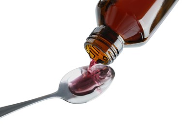 Pouring cough syrup into spoon on white background, above view